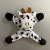 A plush elephant toy with black and white spots and brown ears.