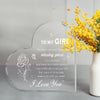 Clear heart-shaped acrylic keepsake with engraved text and a bouquet of yellow flowers