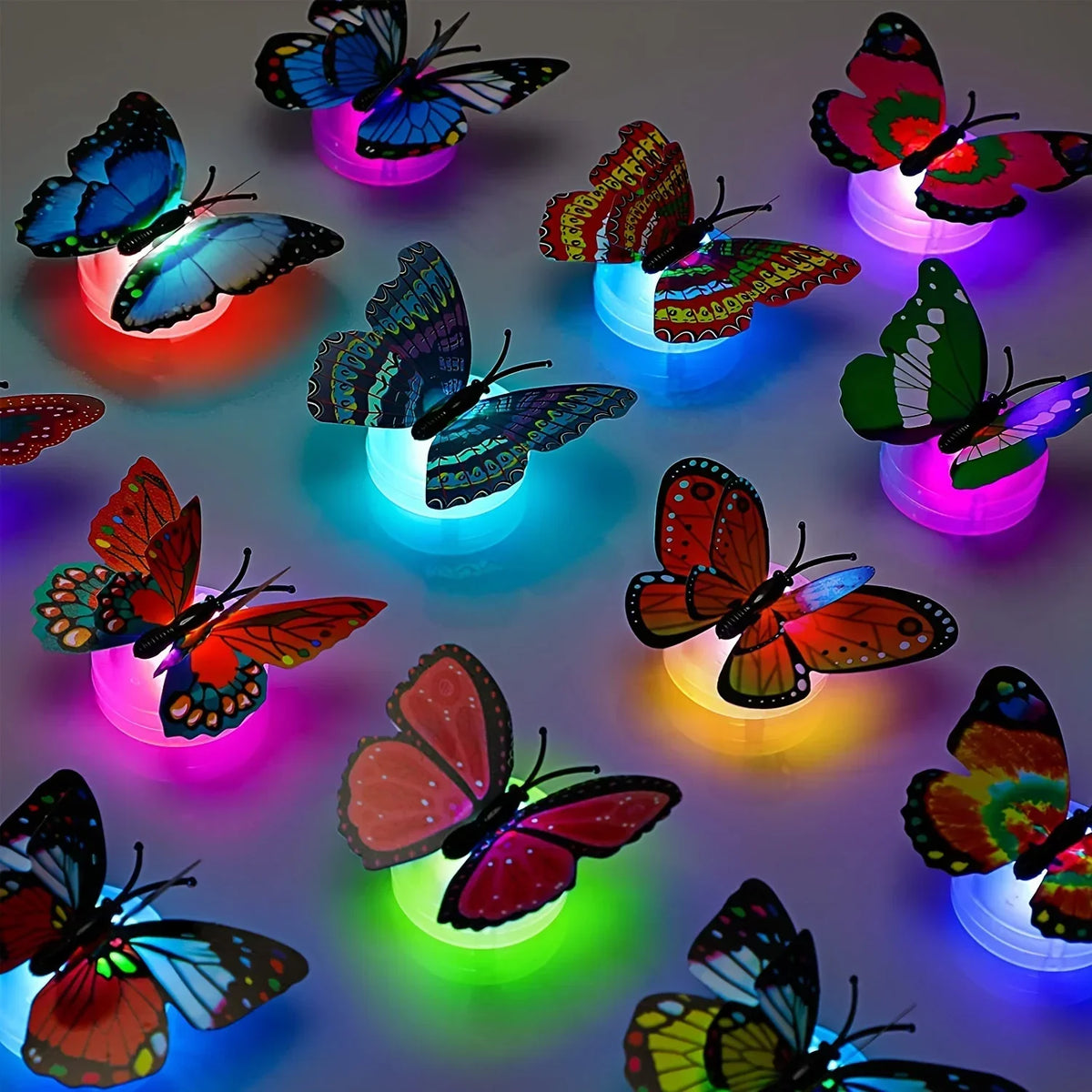مجموعة من ديكورات حائط فراشة LED ثلاثية الأبعاد متوهجة بألوان وأشكال مختلفة.