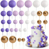 A set of 20 mini foam ball cake toppers in purple, pink, and white colors on gold sticks.