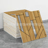 A rectangular panel of wood-grain marble peel-and-stick tiles with silver accents displayed on a gray floor.