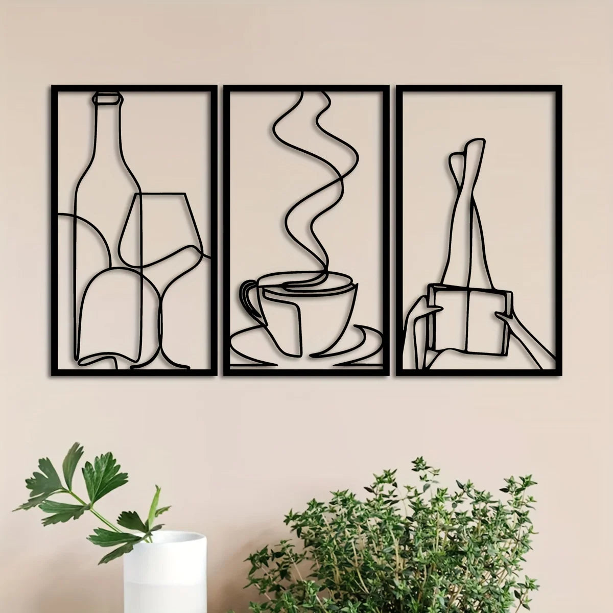 A set of three minimalist metal wall art prints depicting bottles, a steaming cup, and a book.