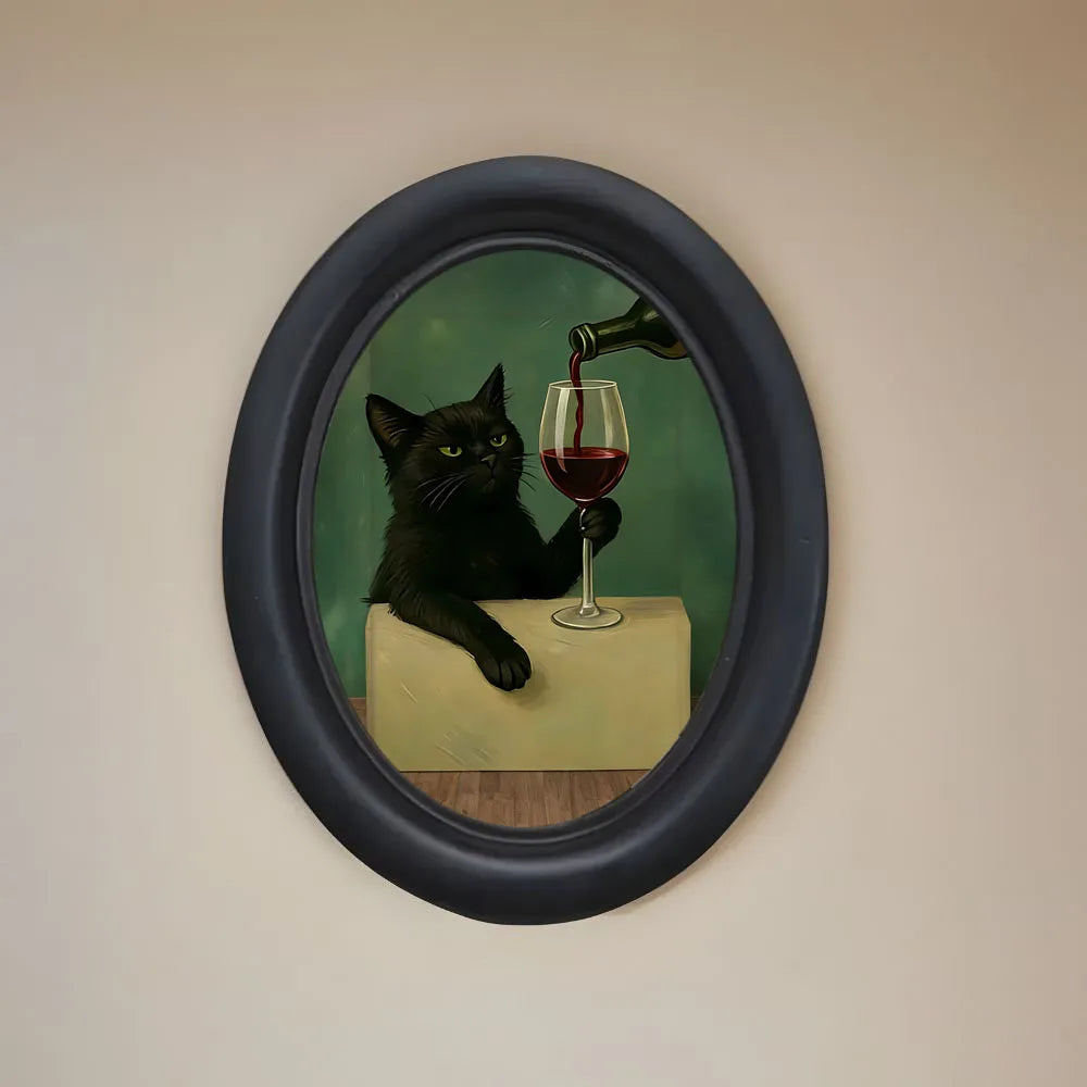 Wall art featuring a black cat drinking red wine in a glass, framed in dark blue.