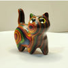 Hand-painted wooden kitten sculpture with vibrant, swirling colors and large eyes.