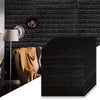 Black 3D foam brick wallpaper panels mounted on a dark textured wall with a lamp and fabric.