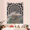 A wall tapestry featuring a psychedelic eye radiating light over a mountain landscape covered in colorful flowers.