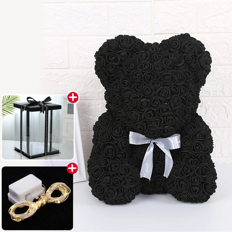 Peluche ours rose noir avec nœud de ruban blanc et décoration lumineuse LED.