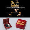 A red music box featuring a gold-colored design of The Godfather logo and hands.