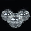 Clear plastic cupcake boxes with decorative rims displayed against a black background.