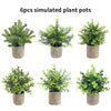 Six simulated potted plants in various shades of green displayed in rustic gray pots.