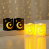 Two yellow LED candles shaped like a crescent moon and star are displayed on a white surface.