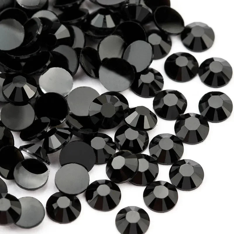 A pile of round black flatback resin rhinestones for crafts and nail art