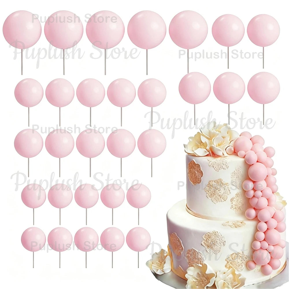 A set of pink and white foam cake toppers, including round balls and floral accents.