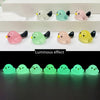 A set of nine small resin bird fairy garden decor pieces in various pastel colors like pink, green, and yellow, showing a lum