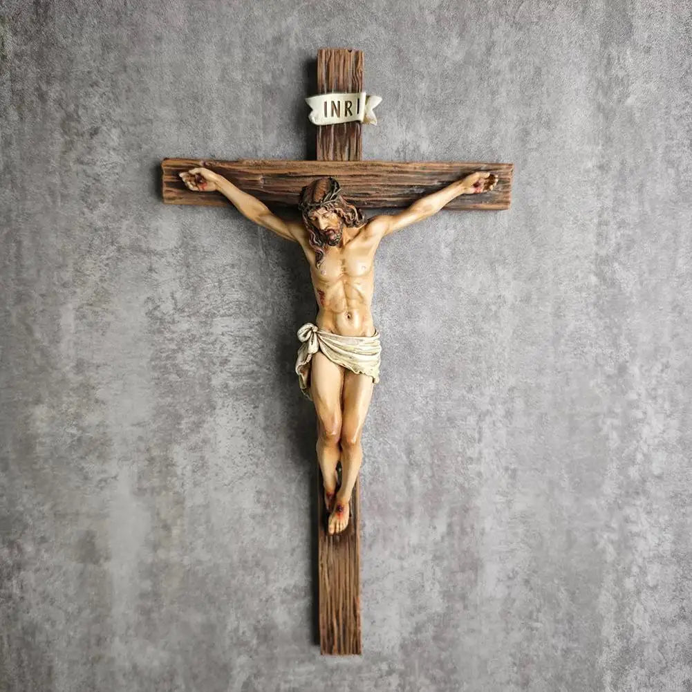 A hand-painted resin cross statue depicting Jesus Christ crucified on a wooden beam.