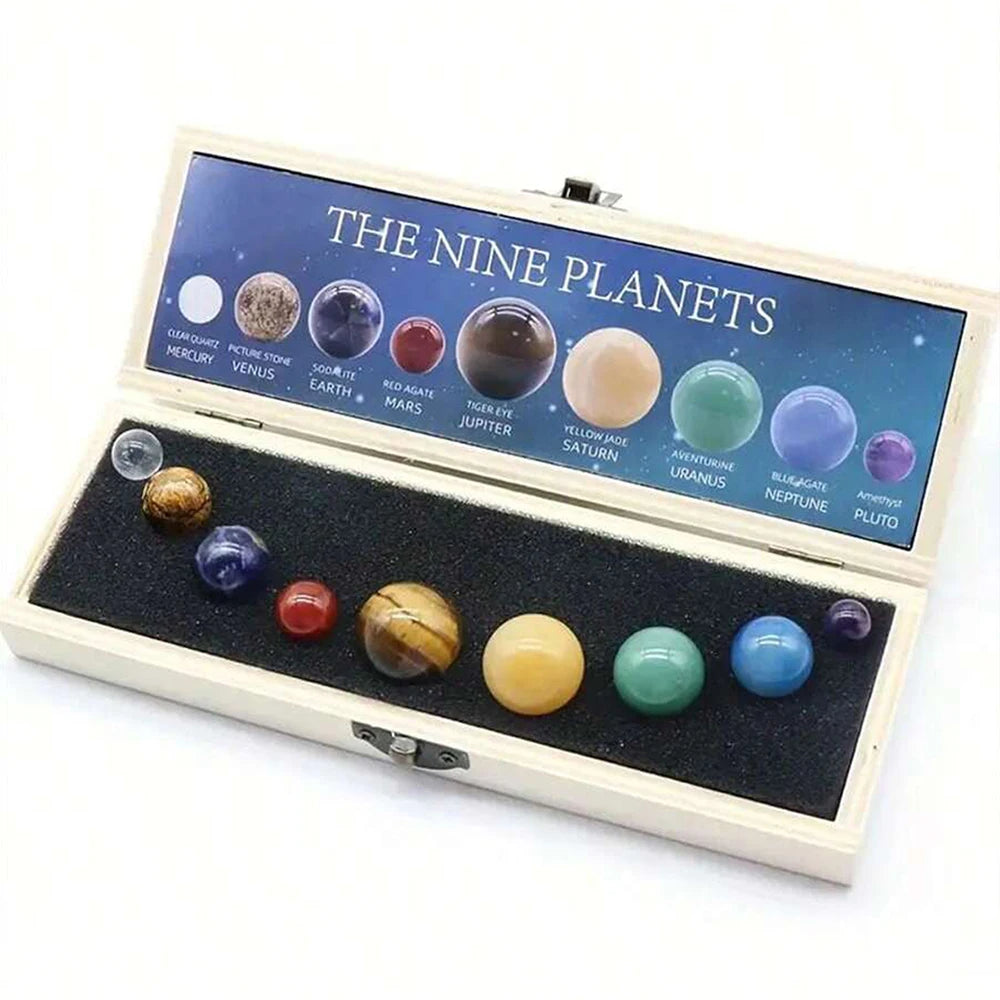 An open wooden box displaying nine natural crystal gemstone spheres representing the nine planets.