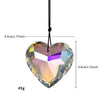 A heart-shaped pendant made of iridescent rainbow-colored glass, suspended by a black cord.