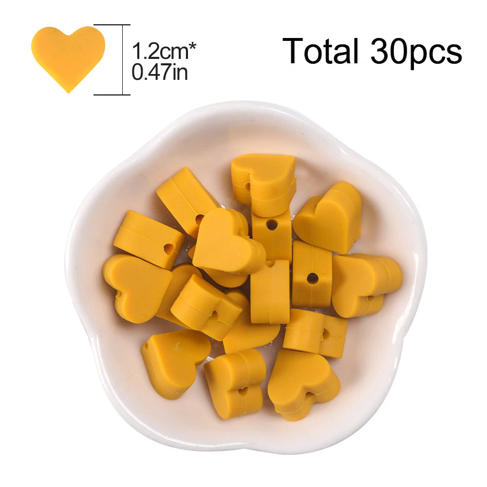 A pile of yellow silicone heart beads for DIY jewelry making, with a size reference and total count.