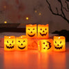 A set of six glowing orange Halloween LED candle lights arranged on a smooth surface.
