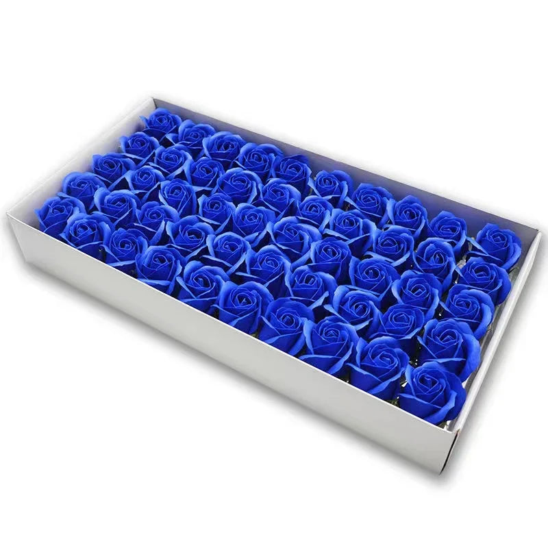 A rectangular box filled with numerous artificial blue rose flower heads.