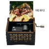 A wooden music box with a hand crank, featuring an illustration of a couple.