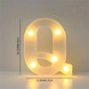 A glowing white letter Q made of LED lights used for room and party decor.