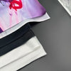 A close-up of a fabric banner featuring pink and purple watercolor designs with black and white stripes.