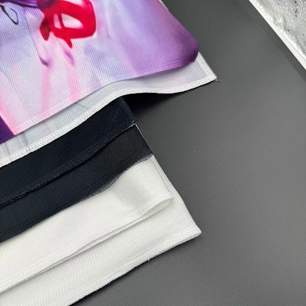 A close-up of a fabric banner featuring pink and purple watercolor designs with black and white stripes.