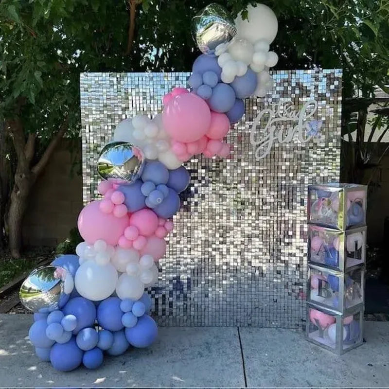 A sparkling backdrop made of iridescent sequins and balloons in shades of pink, purple, and white for a celebration.