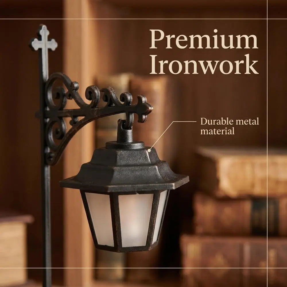 A dark ironwork lantern lamp with a cross finial mounted on a wooden shelf.