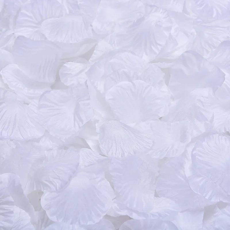 White silk rose petals scattered on a surface for weddings, parties, and home decor