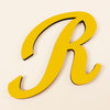 A gold 3D acrylic letter R wall sticker with a shadow effect.