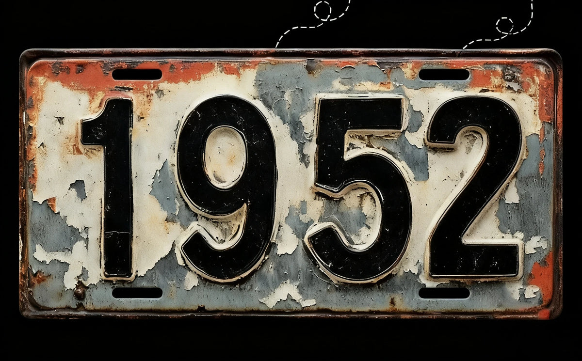 Vintage aluminum license plate tag with the year 1952 embossed on it.