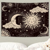 A black tapestry wall hanging featuring a celestial design with a crescent moon, sun, and clouds.