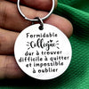 Silver keychain with a white oval engraved with the French quote Formidable Collègue dur à trouver difficile à quitter et imp