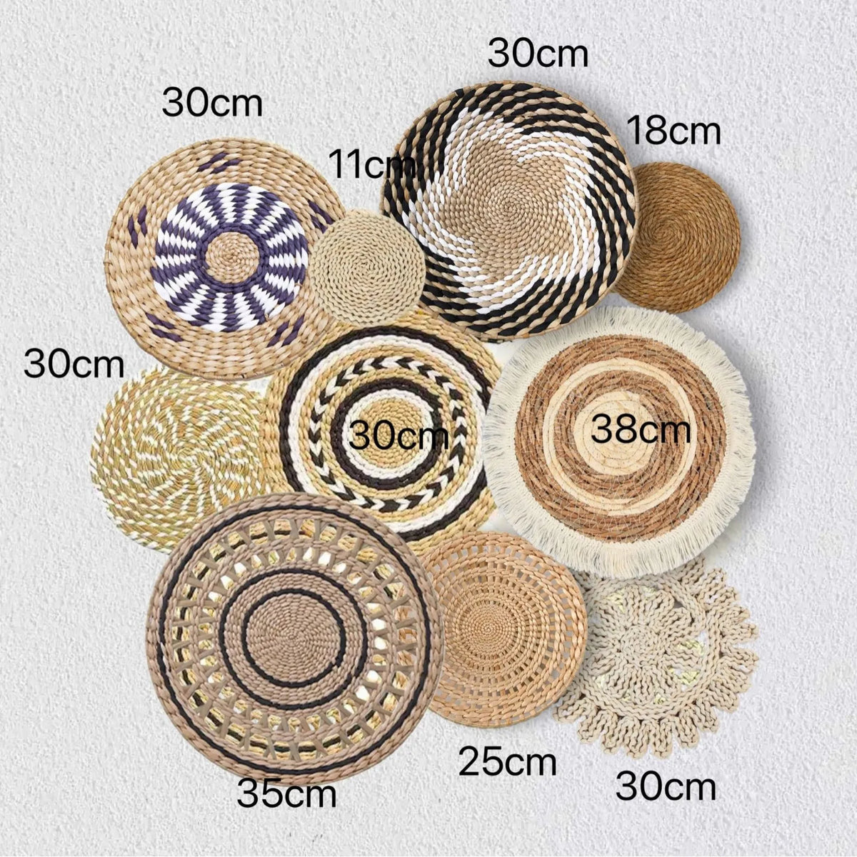 A collection of round boho straw wall hangings in various sizes and shades of natural beige and brown.