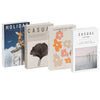 A set of three decorative faux books titled Holiday, Casual, and Casual featuring floral and landscape illustrations.