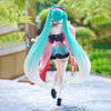 A PVC collectible figurine of Hatsune Miku in a pink and teal outfit with long flowing hair.