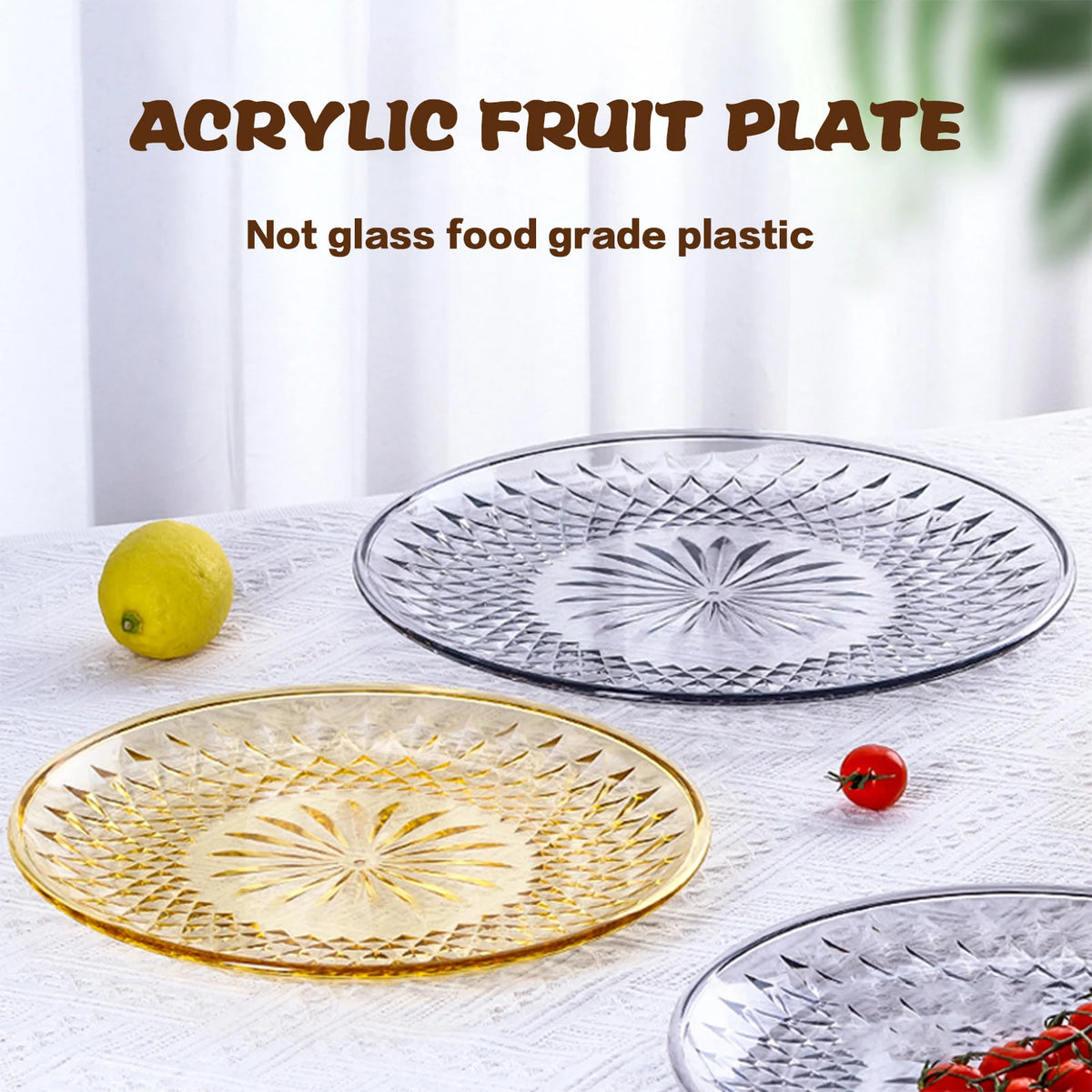 A set of clear acrylic fruit plates, including a round glass plate and a gold-rimmed plate, displayed on a white surface with