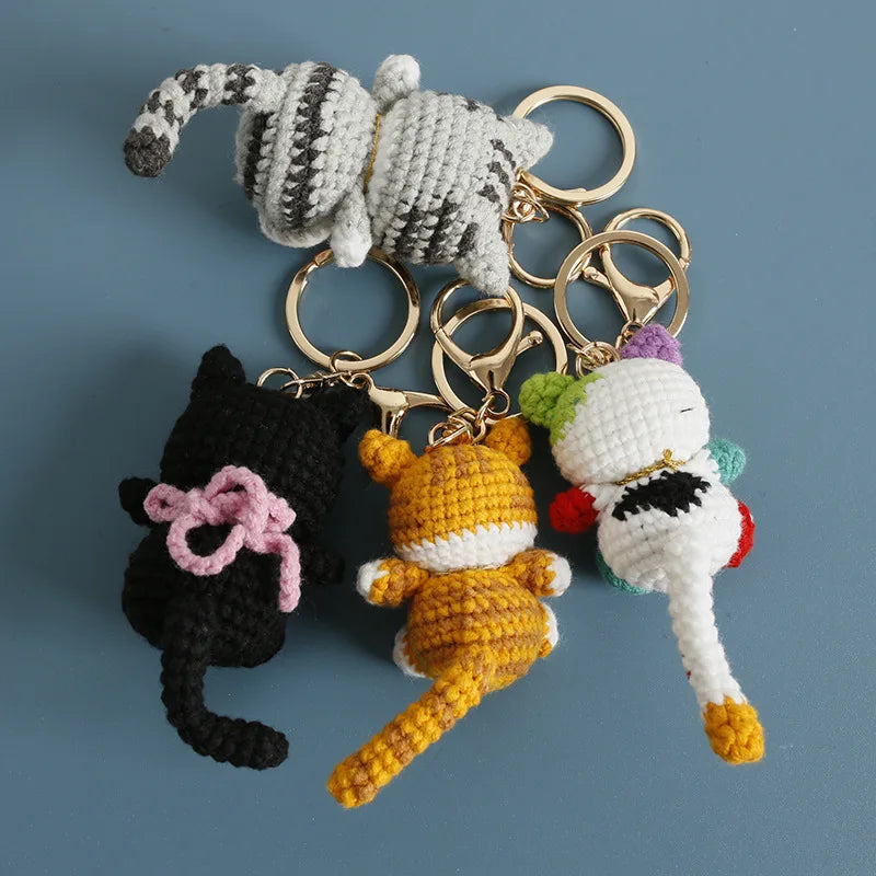 Handcrafted crochet cat keychain pendant featuring a white and gray striped cat figure.