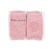 A pair of pink knitted socks with a textured pattern and a circular design on the foot.