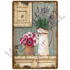 A vintage metal sign featuring a still life of lavender, pink flowers, and a bird on a wooden background.