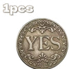 Antique silver-gray decision coin with a floral design featuring the word YES.