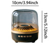 A transparent speaker with an illuminated wooden pattern sits on a dark base.