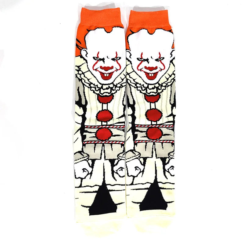 Pair of novelty crew socks featuring skull, alien, and tiger prints with orange trim