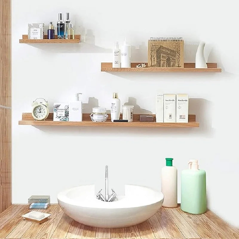 A white ceramic vessel sits on a wooden surface in front of a display of skincare products and various bottles.