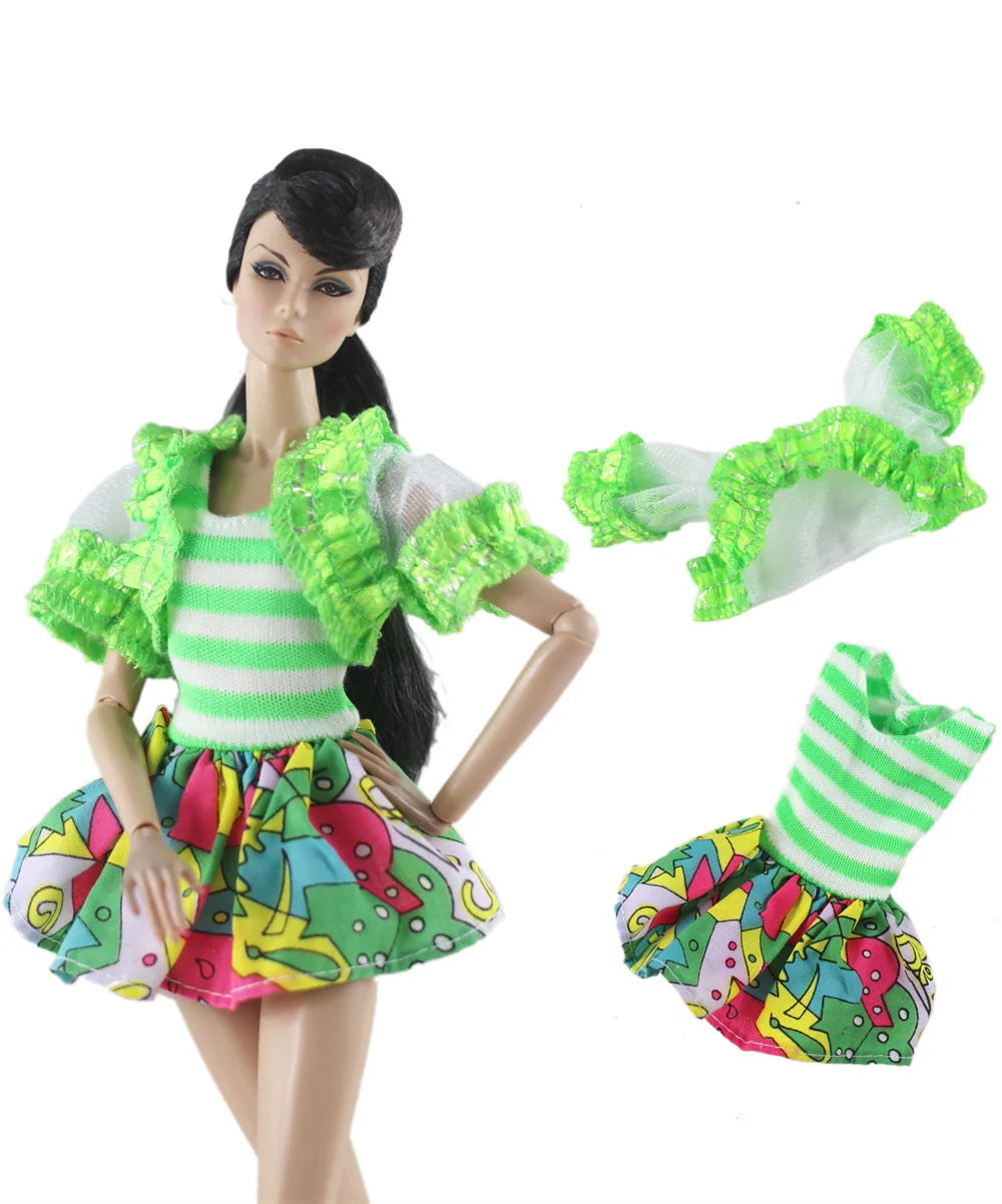 A handmade doll dress gown featuring a striped top, ruffled green collar, and a colorful skirt with dinosaur patterns.