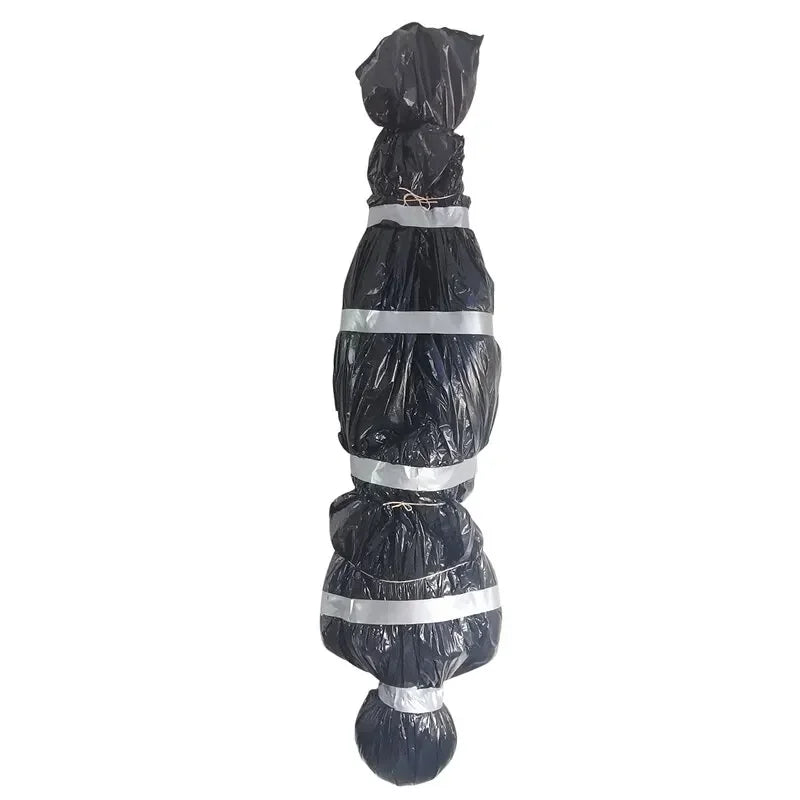 A bundle of realistic dead victim props wrapped in black plastic and secured with silver tape for Halloween decor