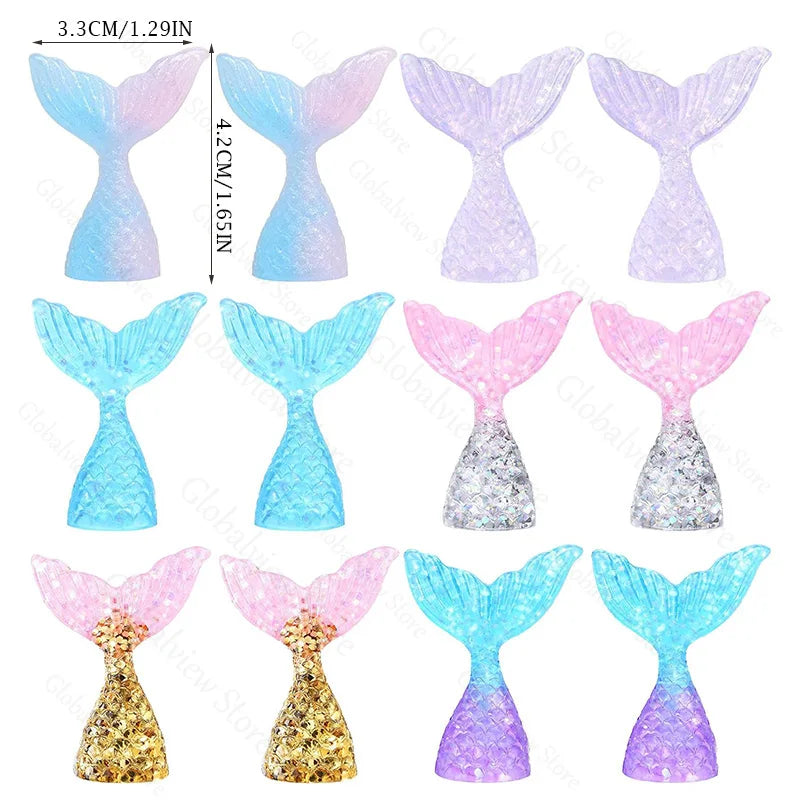 A set of mermaid tail cake toppers featuring various colors and glitter textures like blue, pink, and gold.