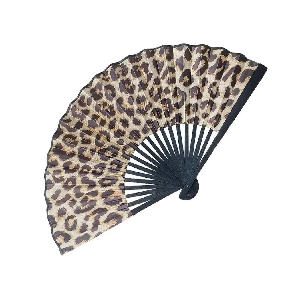 A folding hand fan with a leopard print design in shades of brown and black.